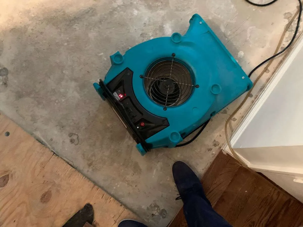 Air mover drying subfloor during Leak Detection & Repair in Hays